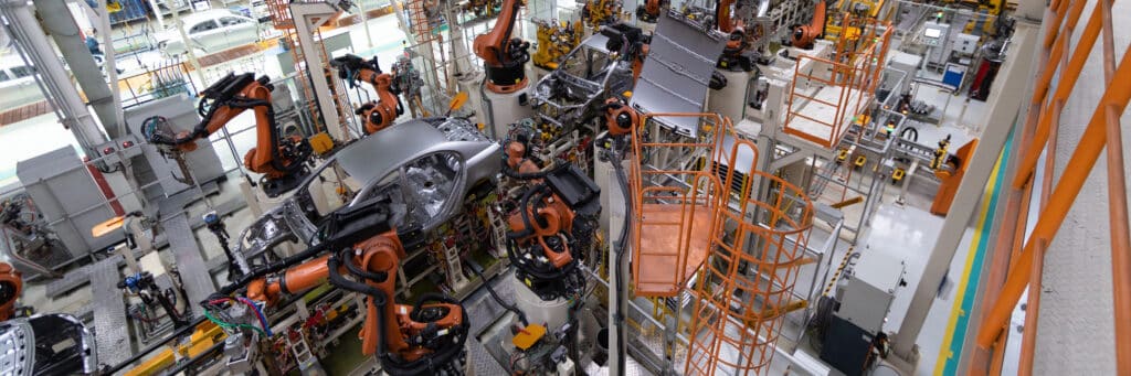 Assembly line production of new car. Automated welding of car body on production line. robotic arm on car production line is working. Wide format shooting automotive. Car factory banner